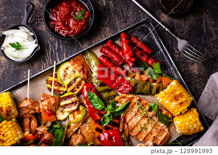 Assortment of grilled bbq meat and vegetables 128991993