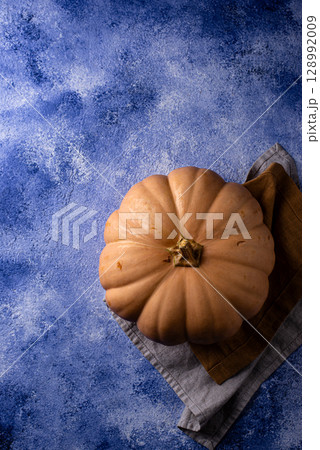 Raw fresh cut pumpkin on dark background 128992009