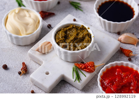 Set of different sauces. Ketchup, mustard, pesto Set of different sauces. Ketchup, mustard, pesto 128992119