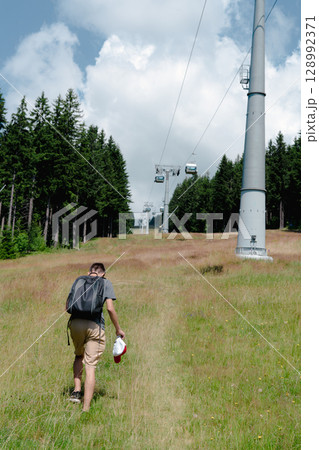 21 July 2025, Cerna Hora in Janskie Lazne, Czech Republic. Cableway System on Cerna Hora mountain. A beautiful sunny summer day. Cabin lift visible from the meadow. 21 July 2025, Cerna Hora in Janskie Lazne, Czech Republic. Cableway System on Cerna Hora mountain. A beautiful sunny summer day. Cabin lift visible from the meadow. 128992371