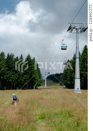 21 July 2025, Cerna Hora in Janskie Lazne, Czech Republic. Cableway System on Cerna Hora mountain. A beautiful sunny summer day. Cabin lift visible from the meadow. 21 July 2025, Cerna Hora in Janskie Lazne, Czech Republic. Cableway System on Cerna Hora mountain. A beautiful sunny summer day. Cabin lift visible from the meadow. 128992372