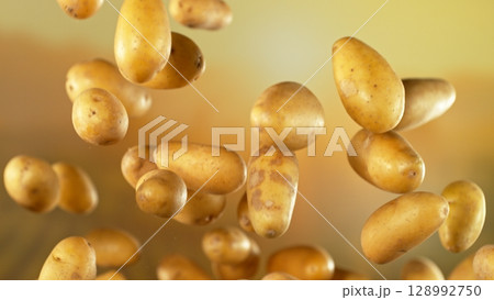 Freeze motion of flying early potatoes , Close-up 128992750