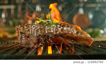 Close-up of Beef Steak on a Grill with Roaring Flames Close-up of Beef Steak on a Grill with Roaring Flames 128992760