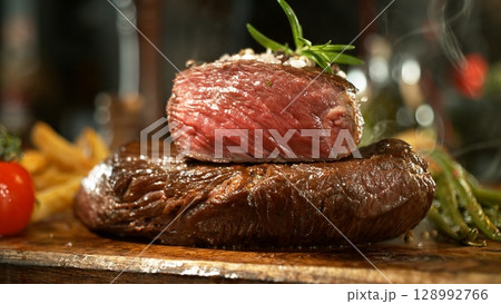 Delicious beef steak on wooden table, close-up Delicious beef steak on wooden table, close-up 128992766