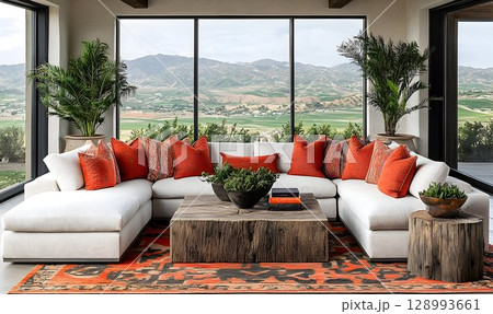 Modern sectional sofa with orange pillows and scenic view 128993661