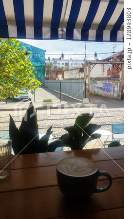 Latte Art and Urban Street View from a Cafe Window Latte Art and Urban Street View from a Cafe Window 128993803