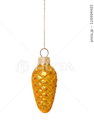 A Christmas decorative tree ornament in the shape of a golden pine cone on a string, isolated on a white background with clipping path. Design element for Christmas card 128994485