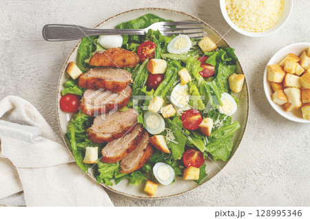 Caesar salad, with duck breast, on a light plate, on a light background, homemade, no people, Caesar salad, with duck breast, on a light plate, on a light background, homemade, no people, 128995346
