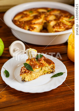 Golden charlotte with juicy filling and sesame seeds on top Golden charlotte with juicy filling and sesame seeds on top 128995625