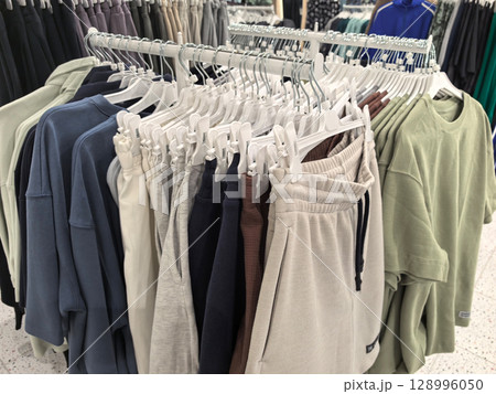 Stylish clothing rack filled with casual attire for modern lifestyles 128996050