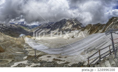 Schnalstal Glacier melting under dramatic sky in Italian Alps Schnalstal Glacier melting under dramatic sky in Italian Alps 128996100