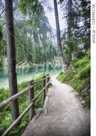 Hiking trail along Lake Braies in the Dolomites mountains, Italy Hiking trail along Lake Braies in the Dolomites mountains, Italy 128996138