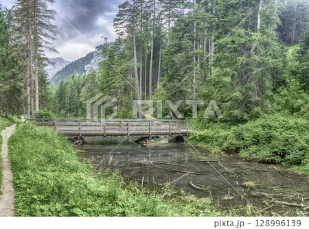 Wooden bridge on Lake Braies in the Dolomites, Italy Wooden bridge on Lake Braies in the Dolomites, Italy 128996139