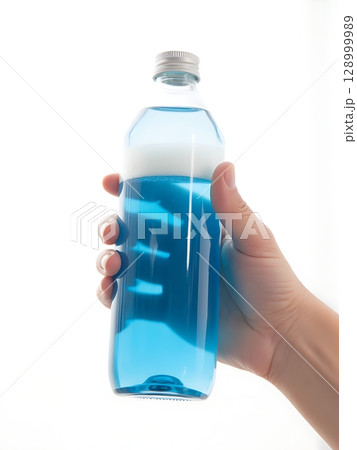 Hand Holding a Clear Glass Bottle of Vibrant Foamy Blue Liquid. 128999989