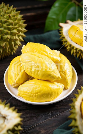Rich Golden Durian Flesh Served Fresh on a White Plate with Spiky Husk. 129000007