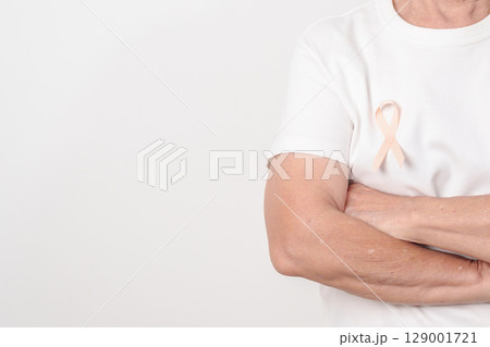 Elderly woman with Peach Ribbon for September Uterine Cancer Awareness month, Endometrial Cancer, Gynecologic, Uterus and Ovaries, Endometriosis, June Vaginal cancer and World cancer day concept 129001721