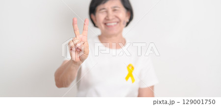 Elderly with Yellow Ribbon for concept of yellow September, Suicide prevention day, Childhood, Pediatric, bone and bladder cancer Awareness month, support survivor. Healthcare and World Cancer day Elderly with Yellow Ribbon for concept of yellow September, Suicide prevention day, Childhood, Pediatric, bone and bladder cancer Awareness month, support survivor. Healthcare and World Cancer day 129001750