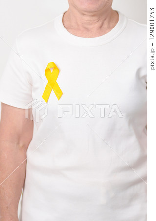 Elderly with Yellow Ribbon for concept of yellow September, Suicide prevention day, Childhood, Pediatric, bone and bladder cancer Awareness month, support survivor. Healthcare and World Cancer day Elderly with Yellow Ribbon for concept of yellow September, Suicide prevention day, Childhood, Pediatric, bone and bladder cancer Awareness month, support survivor. Healthcare and World Cancer day 129001753