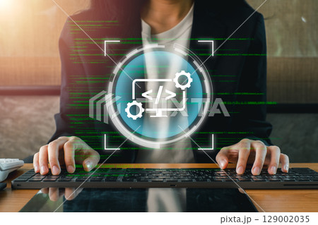 A web developer typing on a keyboard with digital code and interface elements overlay, symbolizing modern web development. 129002035