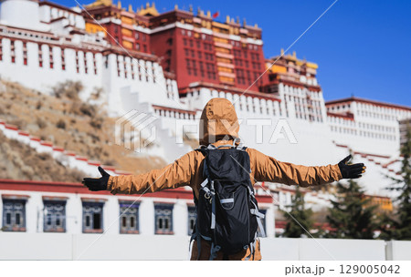 Woman tourist open arms to the potala palace in Lhasa city,Tibet,China Woman tourist open arms to the potala palace in Lhasa city,Tibet,China 129005042
