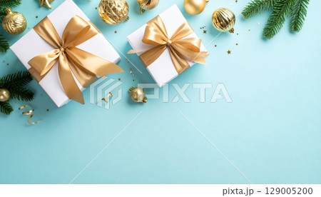 Golden Christmas gift box with a shiny red ribbon and bow, ready for a festive holiday celebration Golden Christmas gift box with a shiny red ribbon and bow, ready for a festive holiday celebration 129005200
