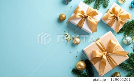 Golden Christmas gift box with a shiny red ribbon and bow, ready for a festive holiday celebration Golden Christmas gift box with a shiny red ribbon and bow, ready for a festive holiday celebration 129005201