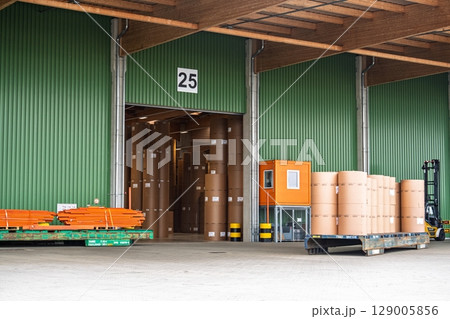 Warehouse Interior with Goods, Forklift, and Loading Dock Area. Industrial Logistics Warehouse Interior with Goods, Forklift, and Loading Dock Area. Industrial Logistics 129005856
