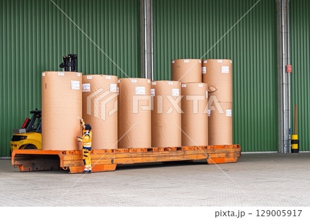Forklift Transporting Large Paper Rolls in Warehouse for Printing Industry, Logistics Forklift Transporting Large Paper Rolls in Warehouse for Printing Industry, Logistics 129005917