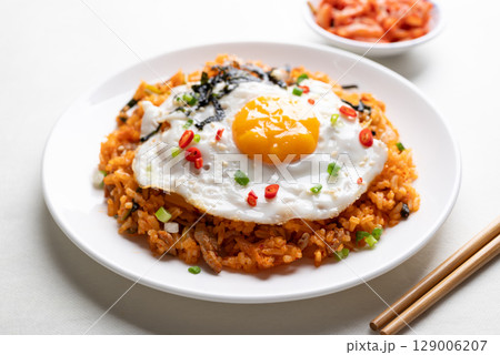 Korean kimchi fried rice with fried egg, pork, sesame seed, chili, spring onion and seaweed Korean kimchi fried rice with fried egg, pork, sesame seed, chili, spring onion and seaweed 129006207