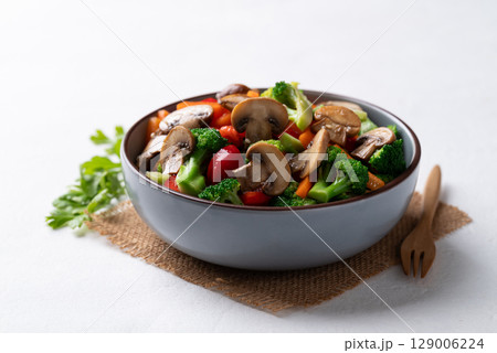 Stir fried vegetables, champignon mushroom, broccoli, bell pepper and carrot with soy sauce 129006224