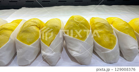Premium Thai durian neatly displayed for sale in a modern supermarket. Premium Thai durian neatly displayed for sale in a modern supermarket. 129008376