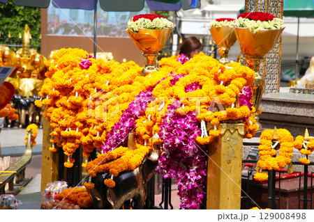 Marigold flower garlands offered for worship at the Erawan Shrine in Bangkok, Thailand. Marigold flower garlands offered for worship at the Erawan Shrine in Bangkok, Thailand. 129008498