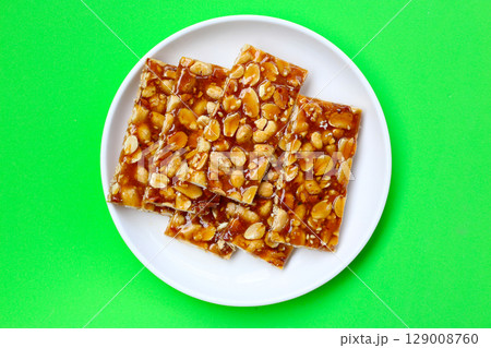 Peanut bars with sweet caramel 129008760