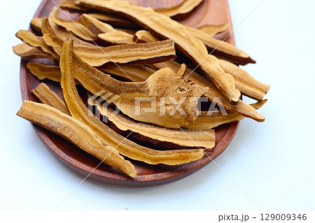 Dried slices of Ganoderma lucidum, also known as reishi mushroom, widely used in traditional medicine for its immune-boosting properties. Dried slices of Ganoderma lucidum, also known as reishi mushroom, widely used in traditional medicine for its immune-boosting properties. 129009346