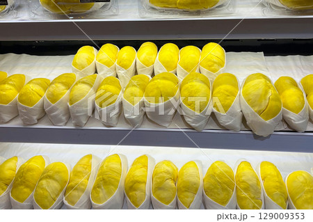 Premium Thai durian neatly displayed for sale in a modern supermarket. Premium Thai durian neatly displayed for sale in a modern supermarket. 129009353