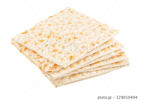Stack of traditional Jewish matzo crackers for Passover, isolated on white background Stack of traditional Jewish matzo crackers for Passover, isolated on white background 129010494