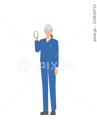 ビジネスイメージ：作業服とヘルメットを身に付けた笑顔の若い女性：スマホを持っている 129010715