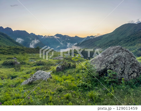 Landscape with low clouds in the mountains Landscape with low clouds in the mountains 129011459