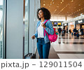 Radiant Traveler with Pink Backpack Gazing Hopefully in Sunlit Airport. 129011504