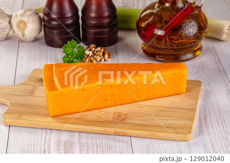 Yellow cheddae cheese over board 129012040