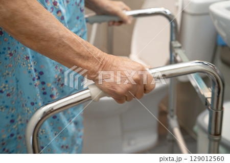 Asian elderly woman patient use walker and toilet bathroom handle security in nursing hospital, healthy strong medical. Asian elderly woman patient use walker and toilet bathroom handle security in nursing hospital, healthy strong medical. 129012560