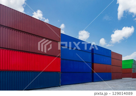 Colorful Shipping Cargo Container Stack Pile against Blue Sky Background in International Industry Port Shipment Terminal Yard at Commercial Harbor, Export logistics Shipping Transportation Backdrop Colorful Shipping Cargo Container Stack Pile against Blue Sky Background in International Industry Port Shipment Terminal Yard at Commercial Harbor, Export logistics Shipping Transportation Backdrop 129014089
