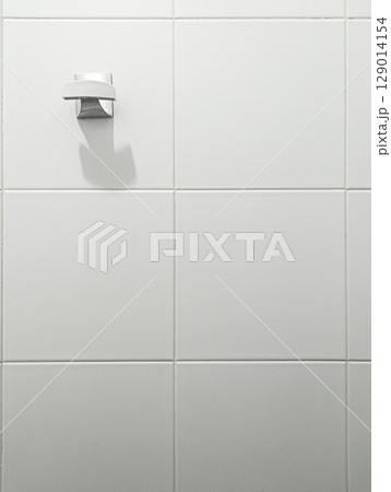 Minimal bathroom wall hook on white tiles 129014154