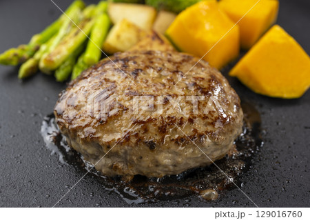鉄板で焼き上げるジューシーなハンバーグと野菜 129016760