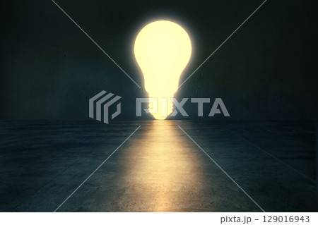 Glowing light bulb in dark empty room. 129016943