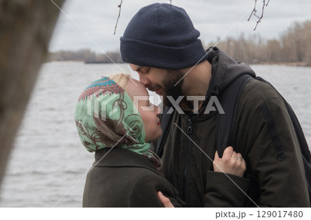Kissing couple. Man and woman in love, outdoors lifestyle portrait 129017480