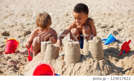 Children Playing in Sand, Creative Fun, Innocence, Beach Play. Ideal for toy brands, family life, childhood memories 129017622