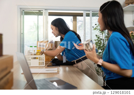 Volunteer organizing donations, showcasing teamwork and support 129018101