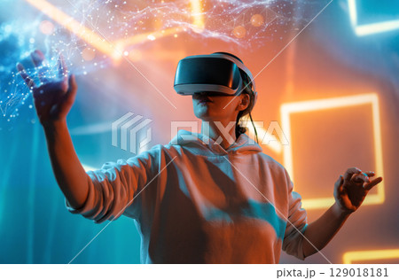 Woman with VR virtual reality goggles 129018181