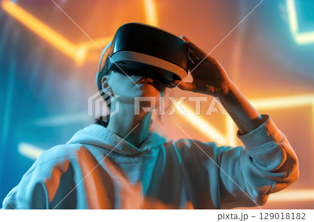 Woman with VR virtual reality goggles 129018182
